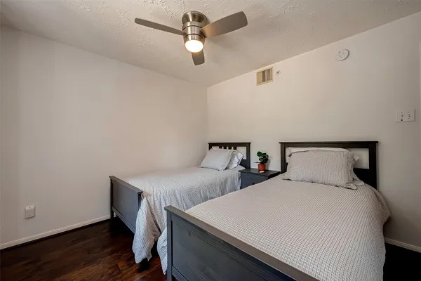 a bedroom with two beds and a chandelier