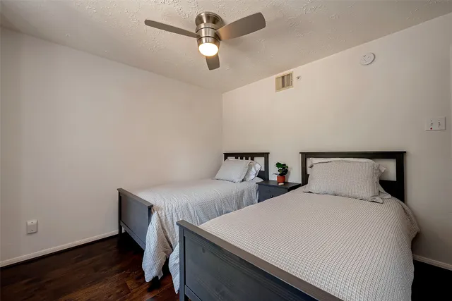 a bedroom with two beds and a chandelier