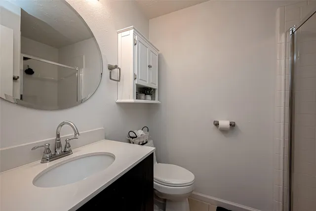 a bathroom with a sink toilet and mirror
