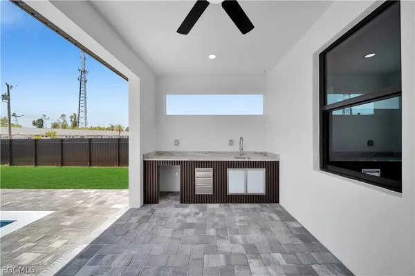 a view of an empty room with a kitchen and a garden