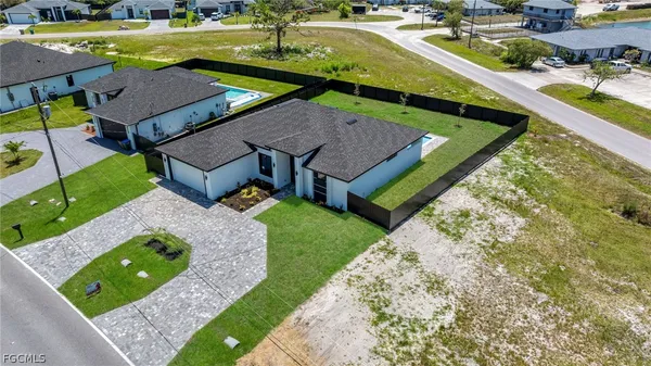 an aerial view of a house with swimming pool outdoor seating and yard
