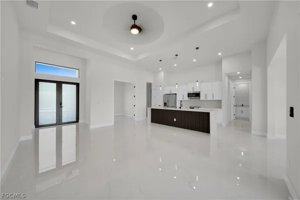 a large white kitchen with a large window