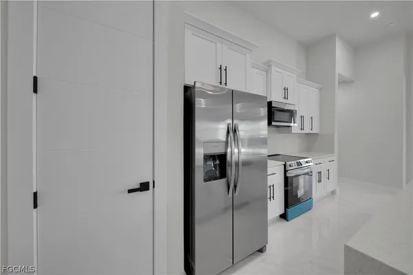 a kitchen with stainless steel appliances a refrigerator sink and stove