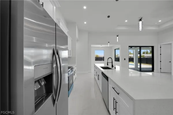 a kitchen with stainless steel appliances a sink stove and refrigerator