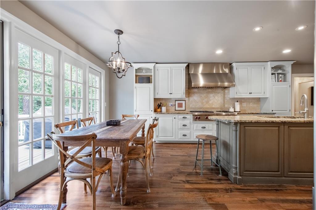 4220 Exeter Close Northwest Atlanta, GA 30327 - Photo 12 of 61 a view of a dining room with furniture window and wooden floor