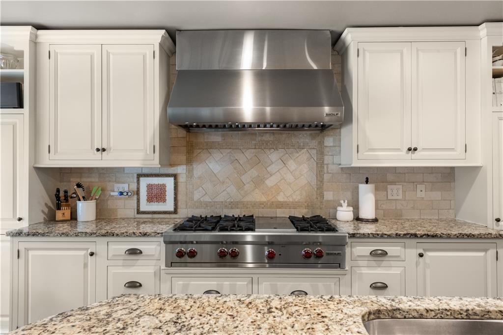 4220 Exeter Close Northwest Atlanta, GA 30327 - Photo 13 of 61 a kitchen with granite countertop white cabinets and stainless steel appliances