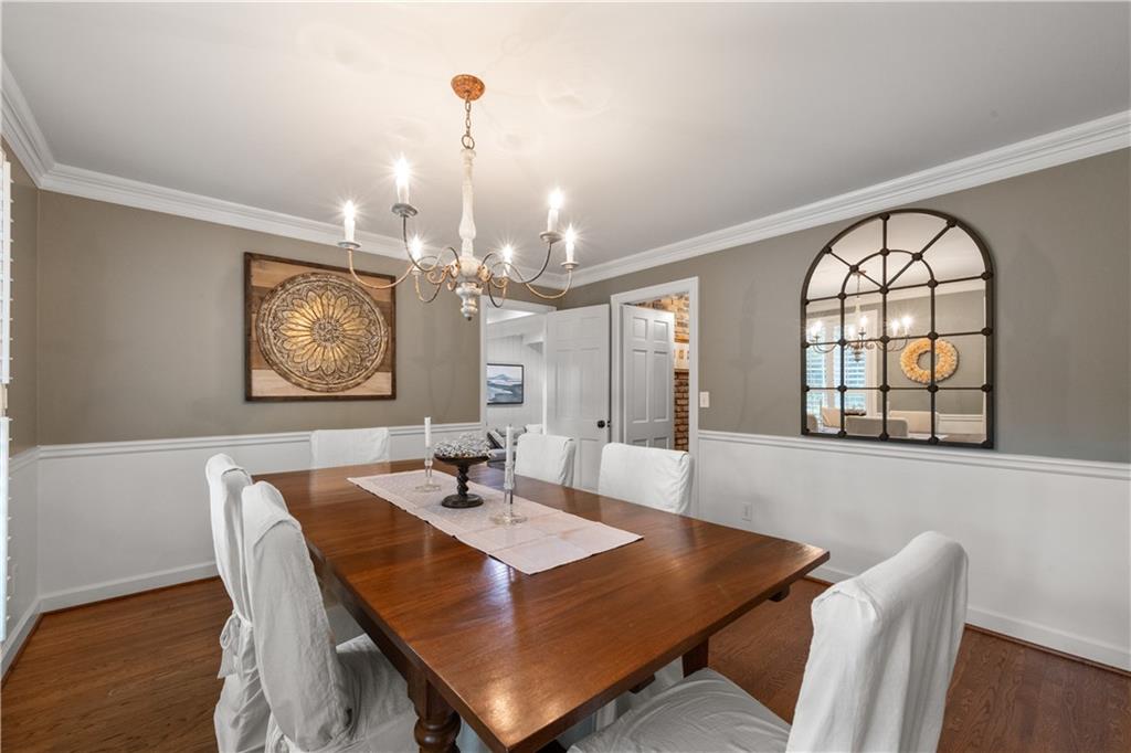 4220 Exeter Close Northwest Atlanta, GA 30327 - Photo 15 of 61 a view of a dining room with furniture window and wooden floor