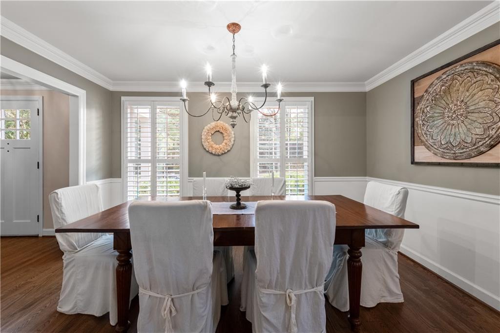 4220 Exeter Close Northwest Atlanta, GA 30327 - Photo 16 of 61 a view of a dining room with furniture and chandelier