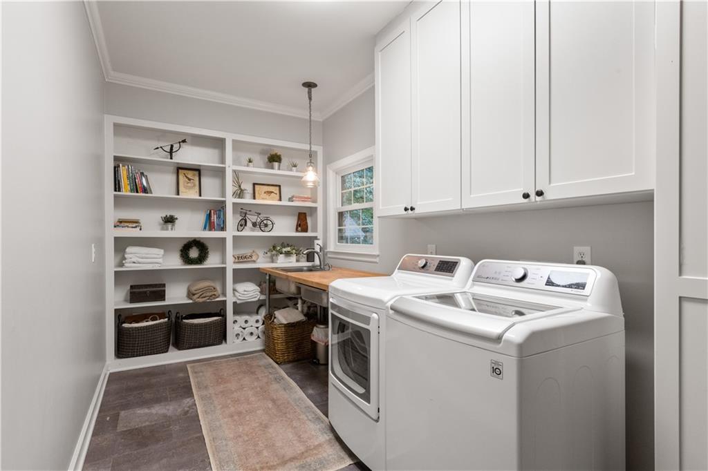 4220 Exeter Close Northwest Atlanta, GA 30327 - Photo 24 of 61 a view of cabinets with washer and dryer