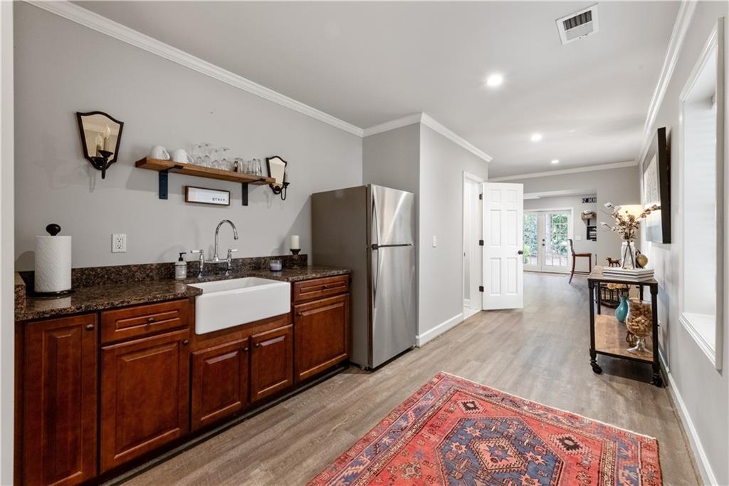 4220 Exeter Close Northwest Atlanta, GA 30327 - Photo 26 of 61 a large kitchen with stainless steel appliances granite countertop a refrigerator and a sink