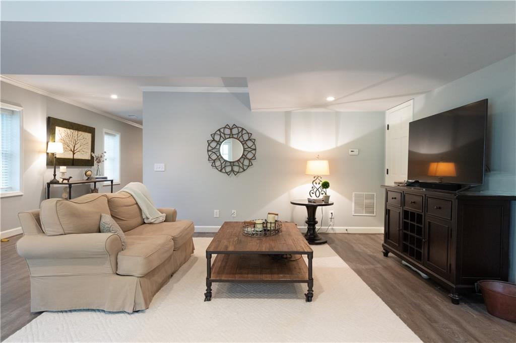 4220 Exeter Close Northwest Atlanta, GA 30327 - Photo 29 of 61 a living room with furniture and a flat screen tv