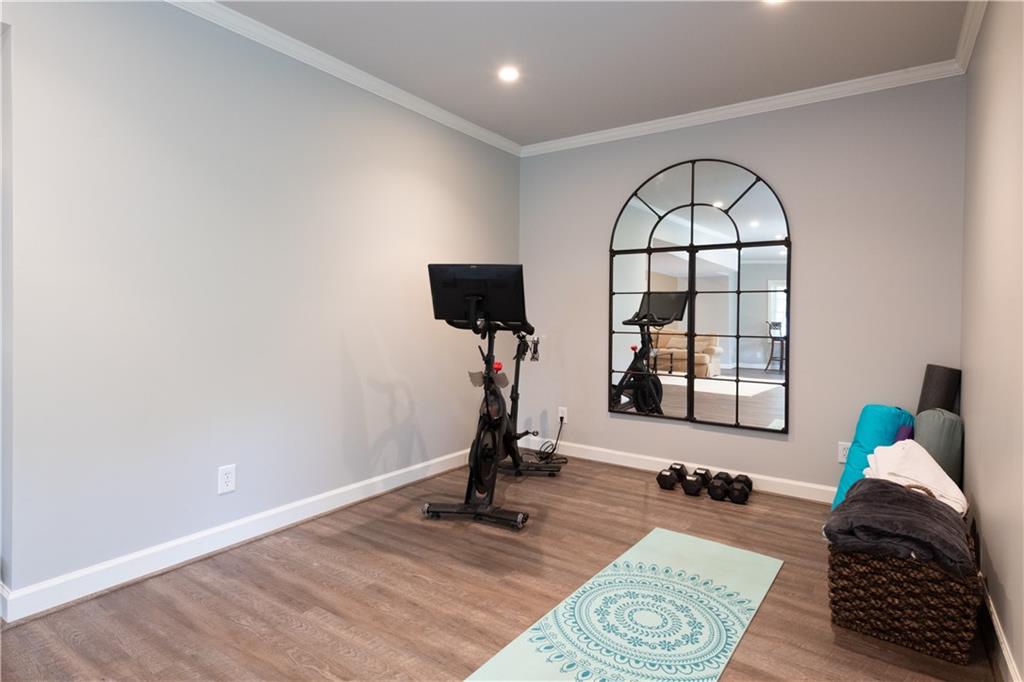 4220 Exeter Close Northwest Atlanta, GA 30327 - Photo 30 of 61 a living room with furniture windows and a wooden floor