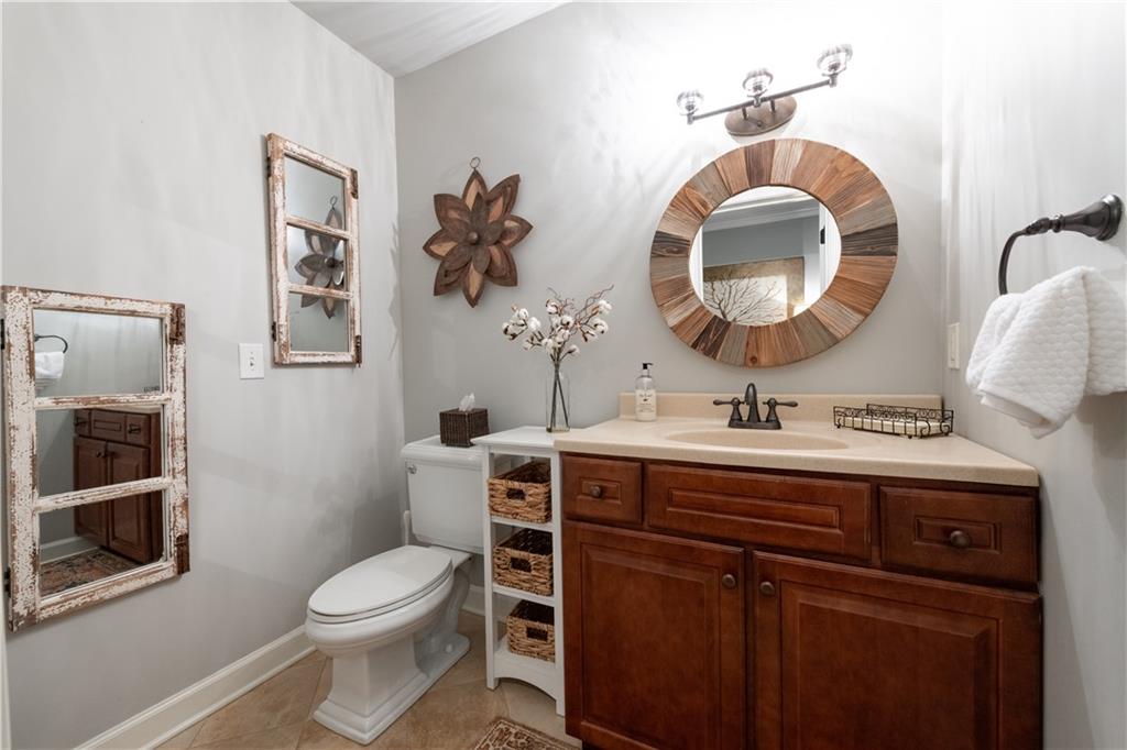 4220 Exeter Close Northwest Atlanta, GA 30327 - Photo 31 of 61 a bathroom with a toilet a sink and mirror