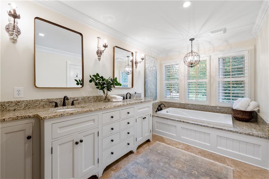 4220 Exeter Close Northwest Atlanta, GA 30327 - Photo 34 of 61 a spacious bathroom with a granite countertop tub sink and mirror