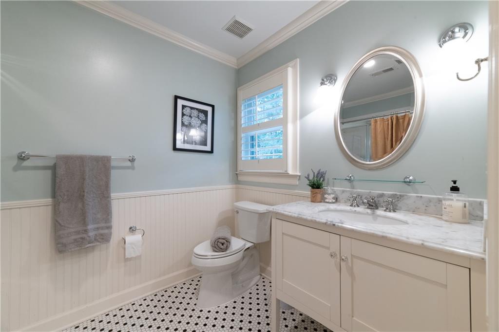 4220 Exeter Close Northwest Atlanta, GA 30327 - Photo 42 of 61 a bathroom with a toilet a sink and mirror