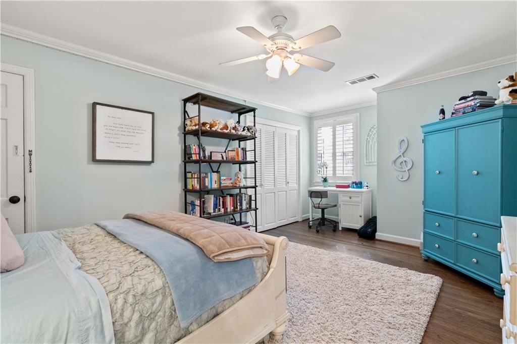 4220 Exeter Close Northwest Atlanta, GA 30327 - Photo 44 of 61 a spacious bedroom with a bed a couch and a window