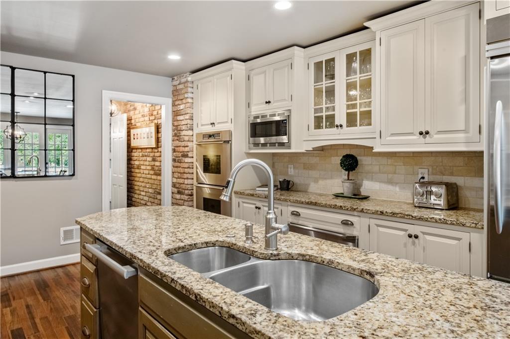 4220 Exeter Close Northwest Atlanta, GA 30327 - Photo 10 of 61 a kitchen with a sink a stove and cabinets