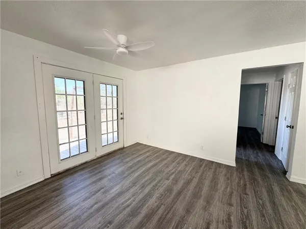 wooden floor in an empty room with a window
