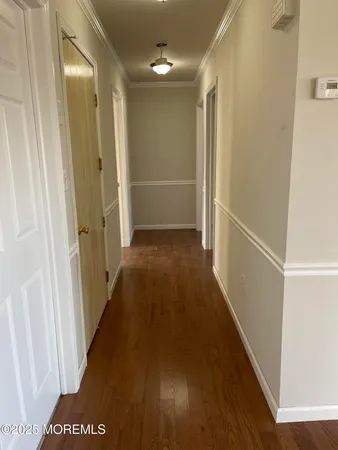 a view of hallway with wooden floor