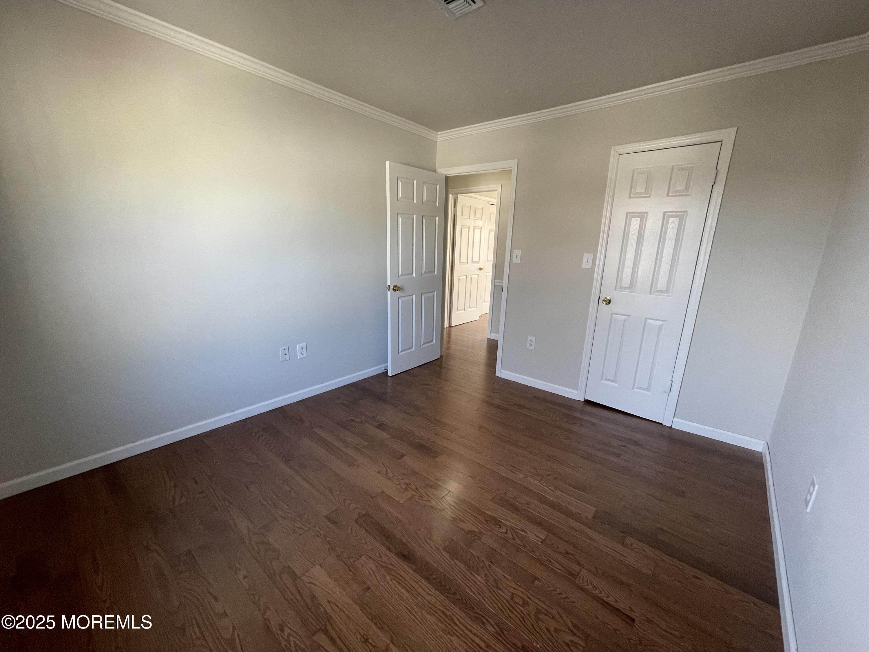 7 Clinton Street, Unit B Matawan, NJ 07747 - Photo 3 of 11 a view of an empty room with wooden floor