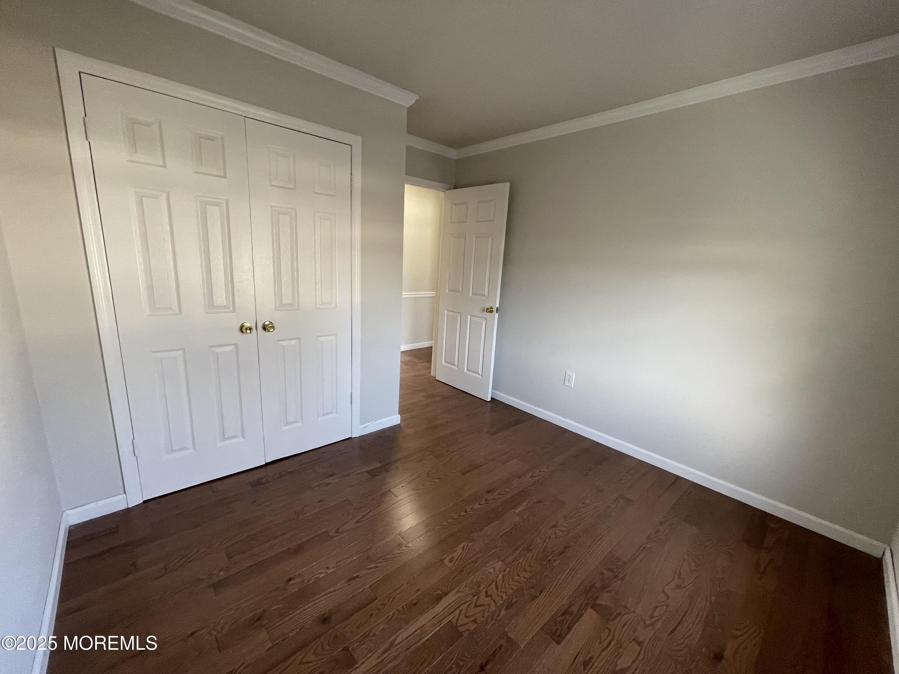 7 Clinton Street, Unit B Matawan, NJ 07747 - Photo 5 of 11 a view of an empty room with wooden floor