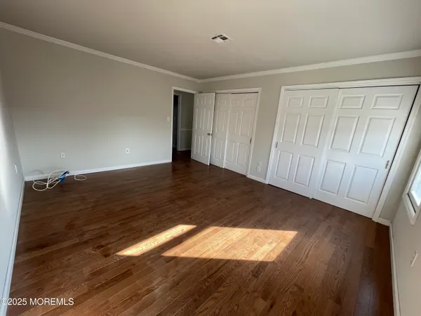 a view of an empty room and wooden floor