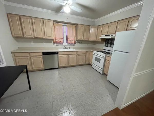 a kitchen with a white cabinets and white appliances