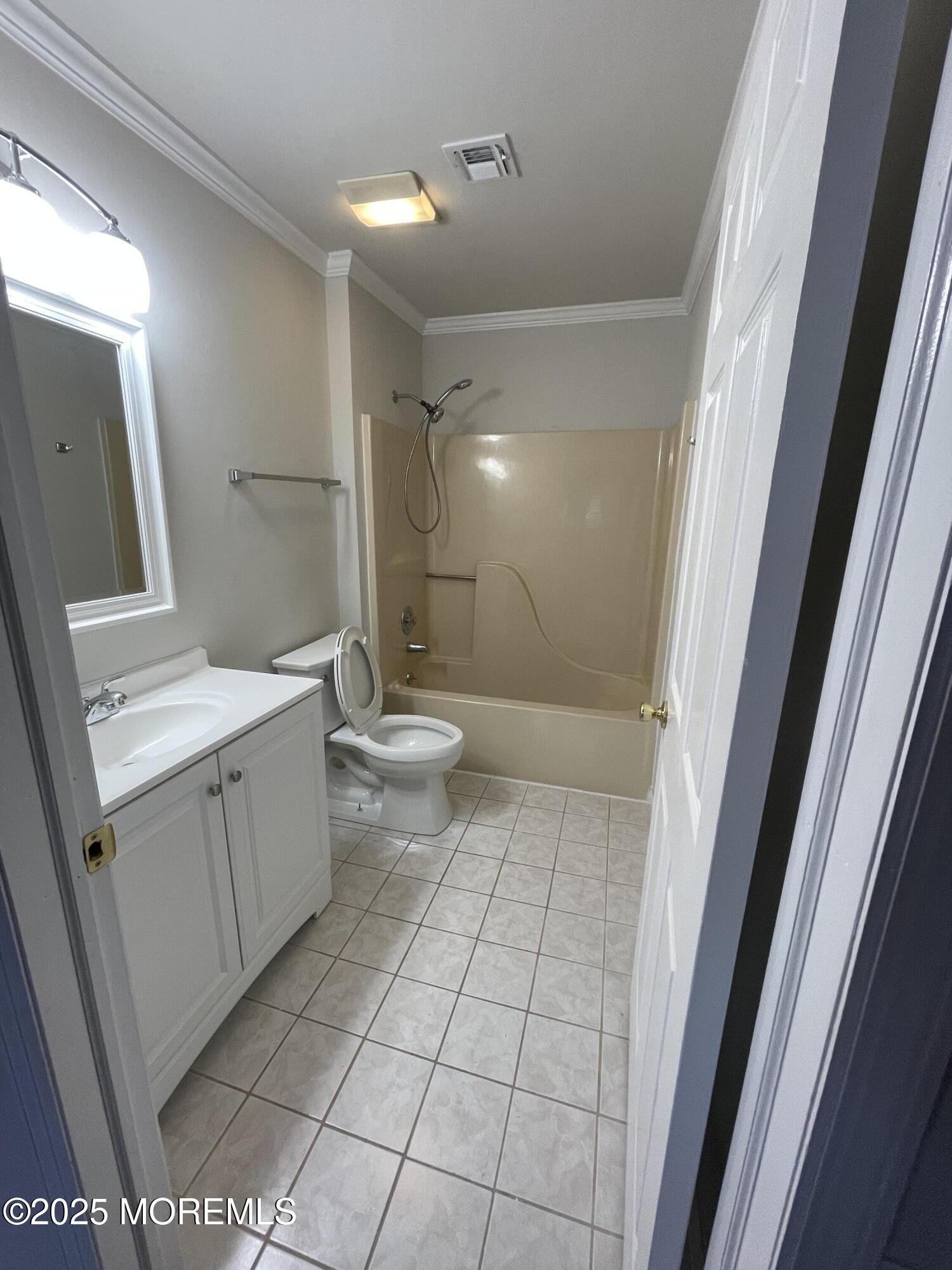 7 Clinton Street, Unit B Matawan, NJ 07747 - Photo 9 of 11 a bathroom with a sink a toilet and shower