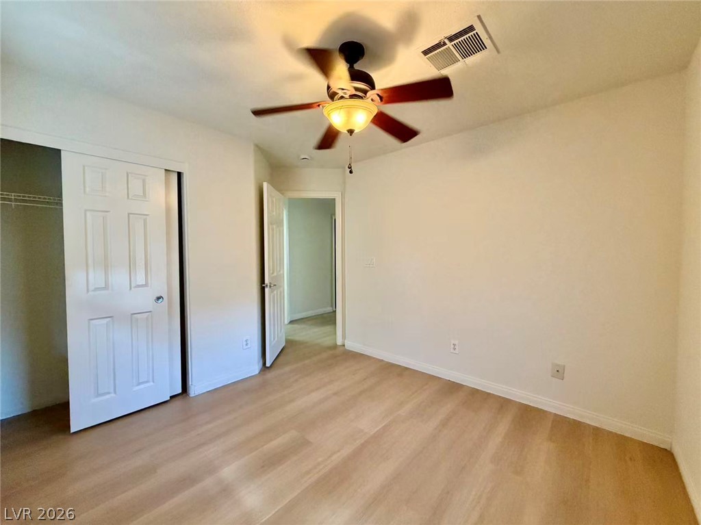 11183 Ranch Valley Street Las Vegas, NV 89179 - Photo 16 of 19 Blonde wood flooring and an inviting ceiling fan create a comfortable and modern personal sanctuary.