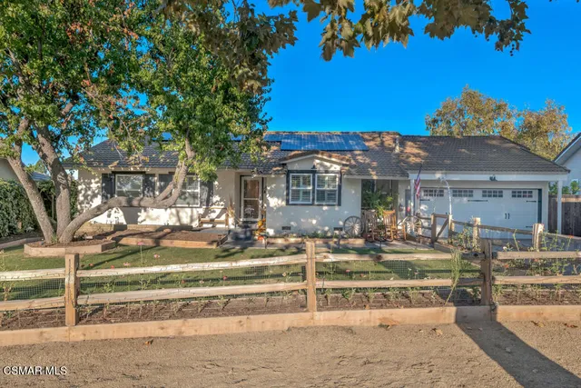 a view of a house with swimming pool and sitting area
