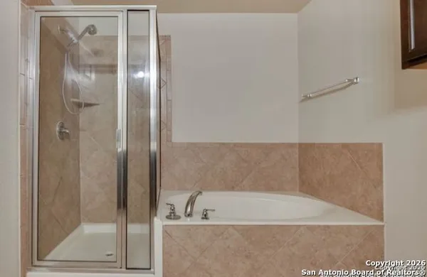 a bathroom with a bathtub and shower