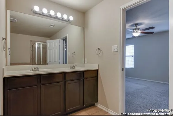 a bathroom with a double vanity sink and a mirror