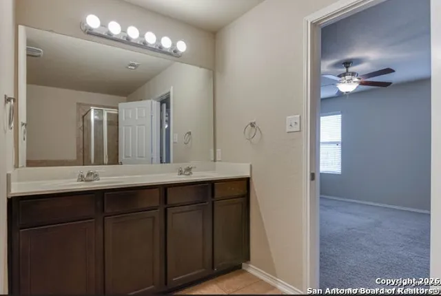 a bathroom with a double vanity sink and a mirror