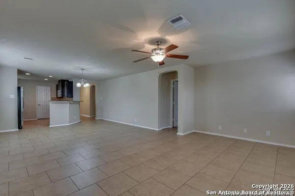 a view of a kitchen with a sink and a chandelier fan
