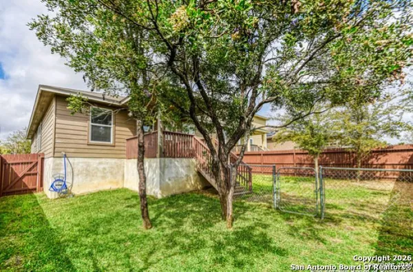 a backyard of a house with table and chairs