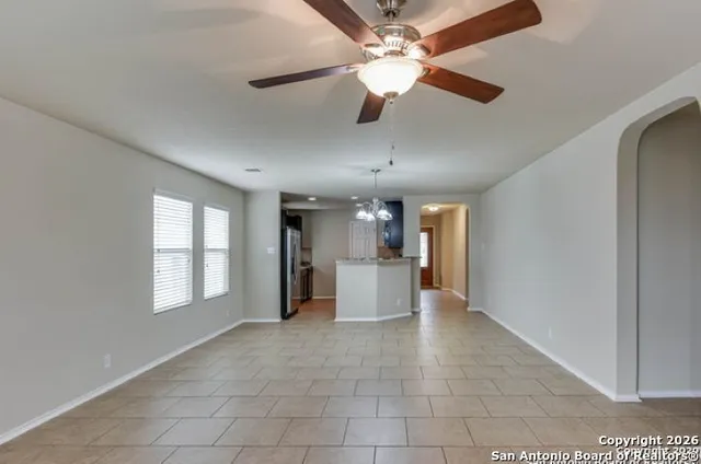 a view of a livingroom with a ceiling fan and window