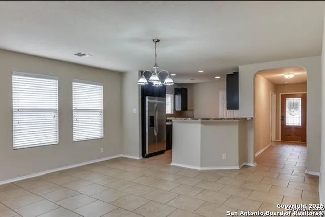 a view of a room with a kitchen