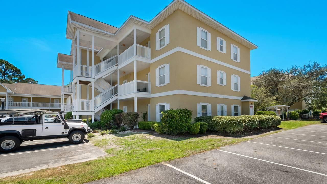 34 Heron's Watch Way, Unit 5101 Santa Rosa Beach, FL 32459 - Photo 12 of 33 a front view of a building with cars parked