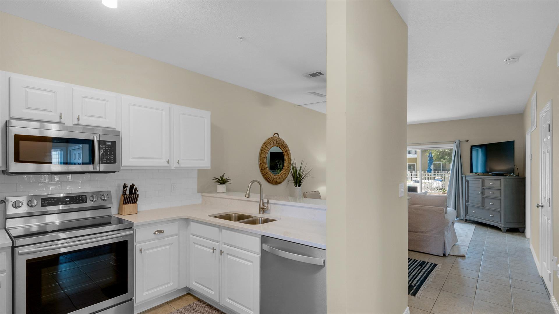 34 Heron's Watch Way, Unit 5101 Santa Rosa Beach, FL 32459 - Photo 13 of 33 a kitchen with stainless steel appliances granite countertop a sink stove and refrigerator