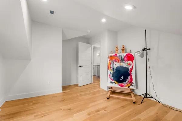 a bed sitting in a bedroom next to a window