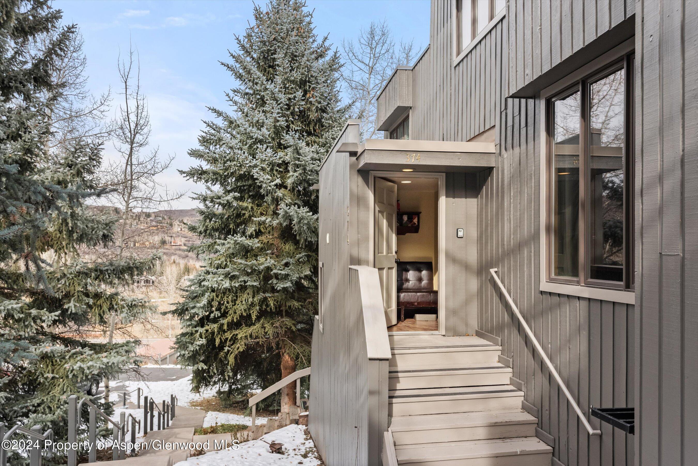 374 Meadow Ranch Road Snowmass Village, CO 81615 - Photo 2 of 22 a view of a white house with a large windows