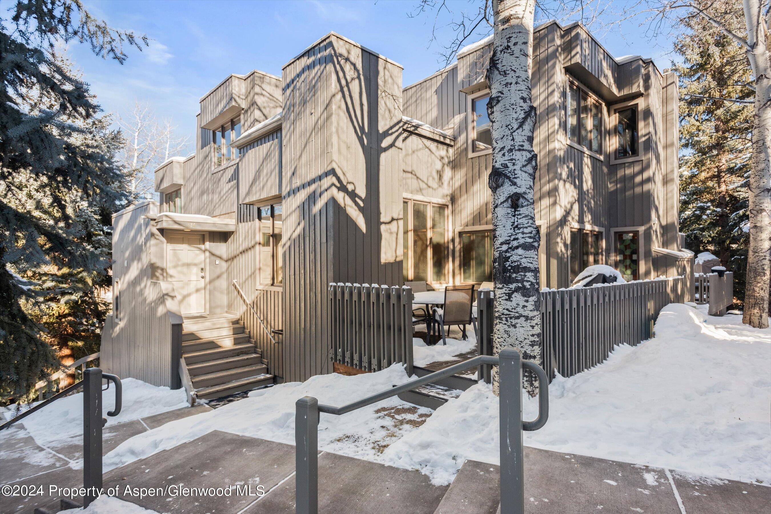 374 Meadow Ranch Road Snowmass Village, CO 81615 - Photo 22 of 22 a view of a house with a tree and wooden fence