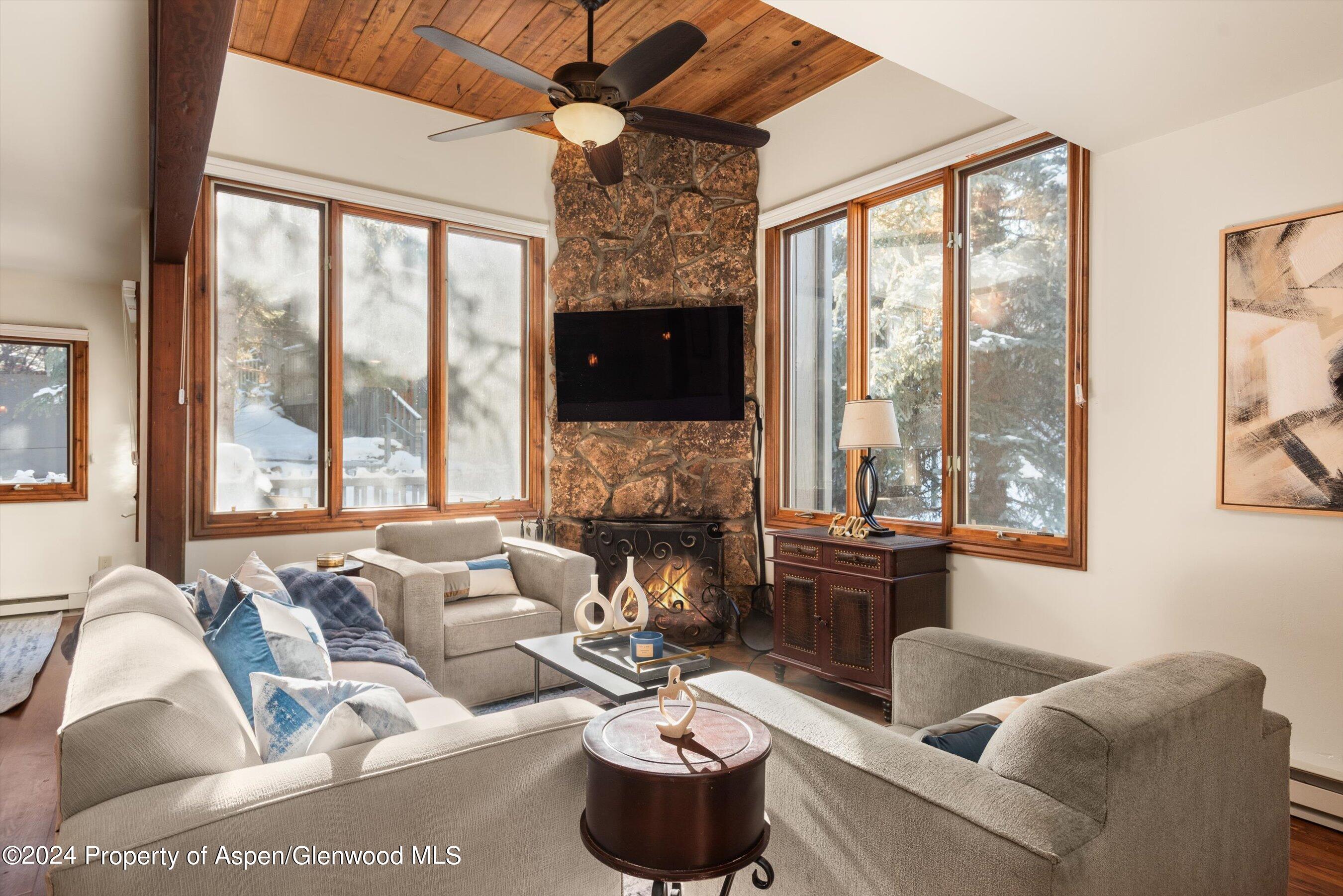 374 Meadow Ranch Road Snowmass Village, CO 81615 - Photo 4 of 22 a living room with furniture large window and flat screen tv