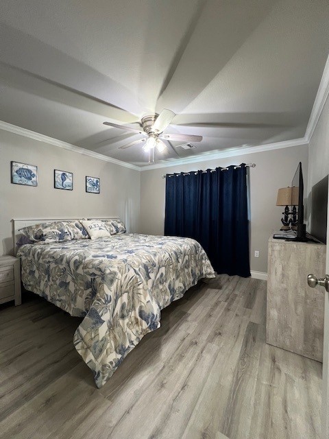 182 County Road 257 Matagorda, TX 77457 - Photo 13 of 24 a bedroom with a large bed and a chandelier