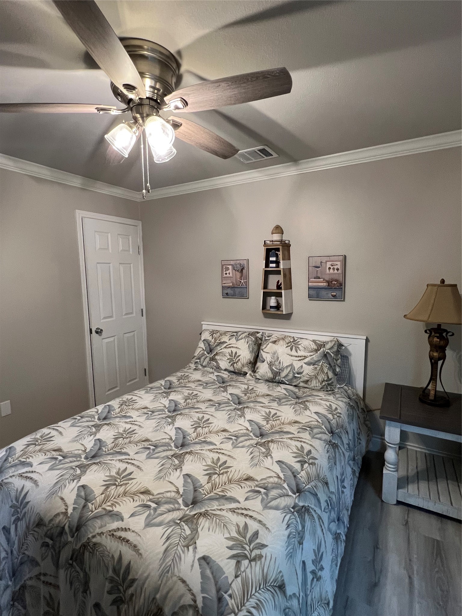 182 County Road 257 Matagorda, TX 77457 - Photo 16 of 24 a bedroom with a large bed and a chandelier