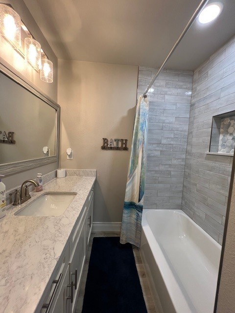 182 County Road 257 Matagorda, TX 77457 - Photo 18 of 24 a bathroom with a granite countertop sink a toilet a bathtub and shower