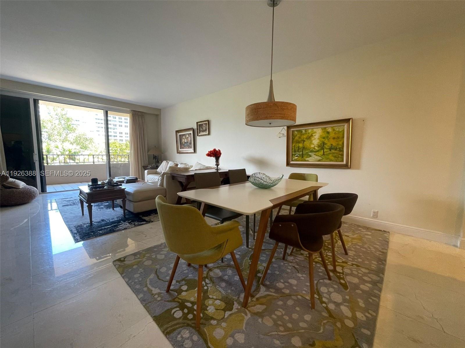 251 Crandon Boulevard, Unit 233 Key Biscayne, FL 33149 - Photo 1 of 27 a living room with furniture a window and a table