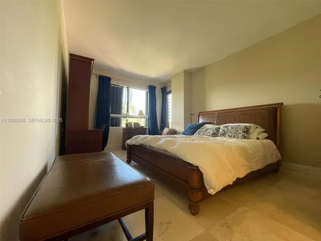 a bedroom with a bed and a chair