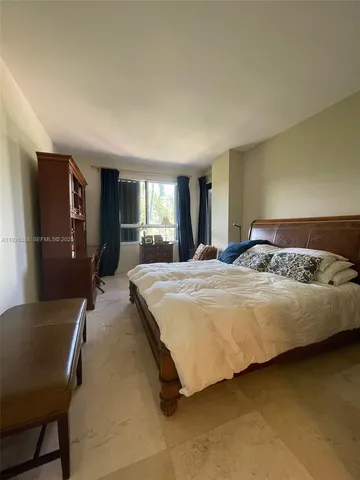 a bedroom with a bed and cabinets