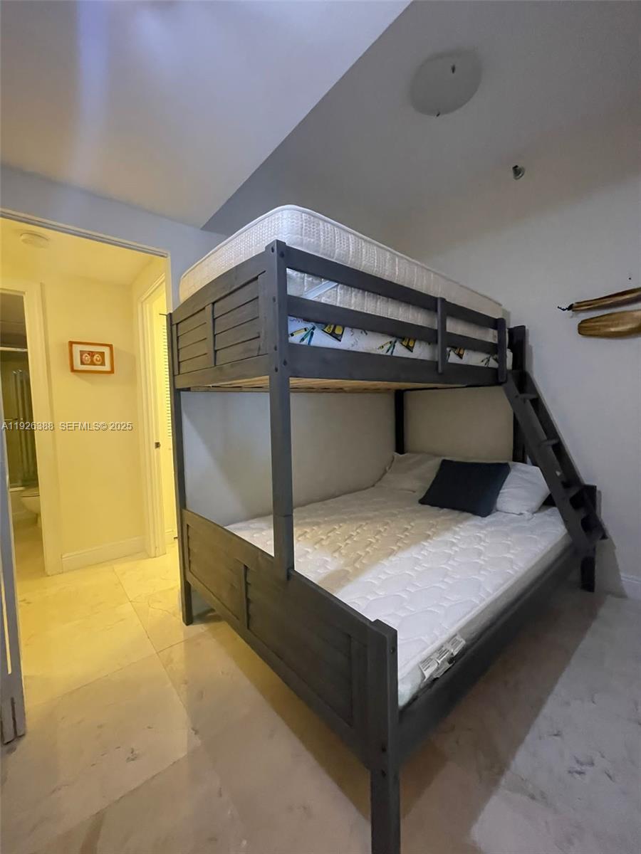 251 Crandon Boulevard, Unit 233 Key Biscayne, FL 33149 - Photo 17 of 27 a bedroom with a bed and cabinets